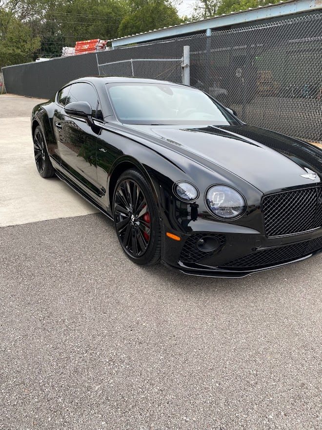 Black Bentley Continental outside the shop