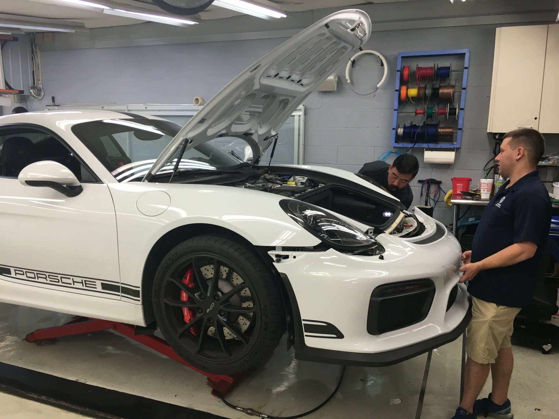 White Porsche on the lift in the Sunbusters shop