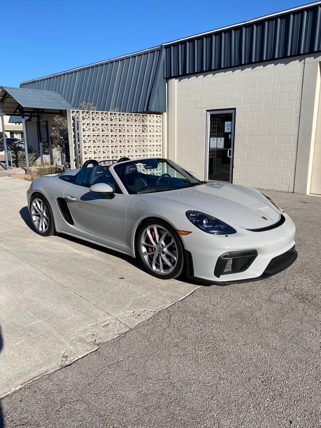 White Porsche Spyder outside the shop