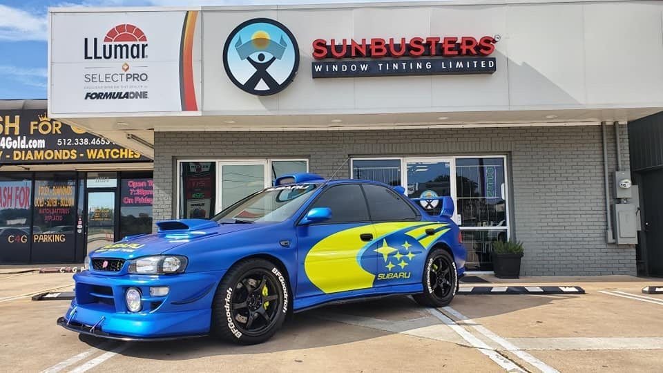 Blue Subaru in front of the shop