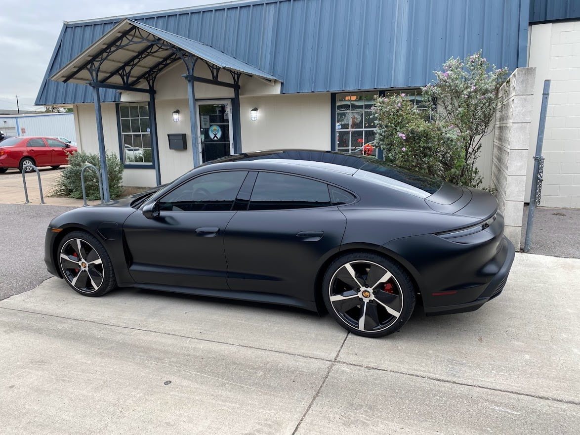 Matte Porsche Taycan in front of the Sunbusters shop