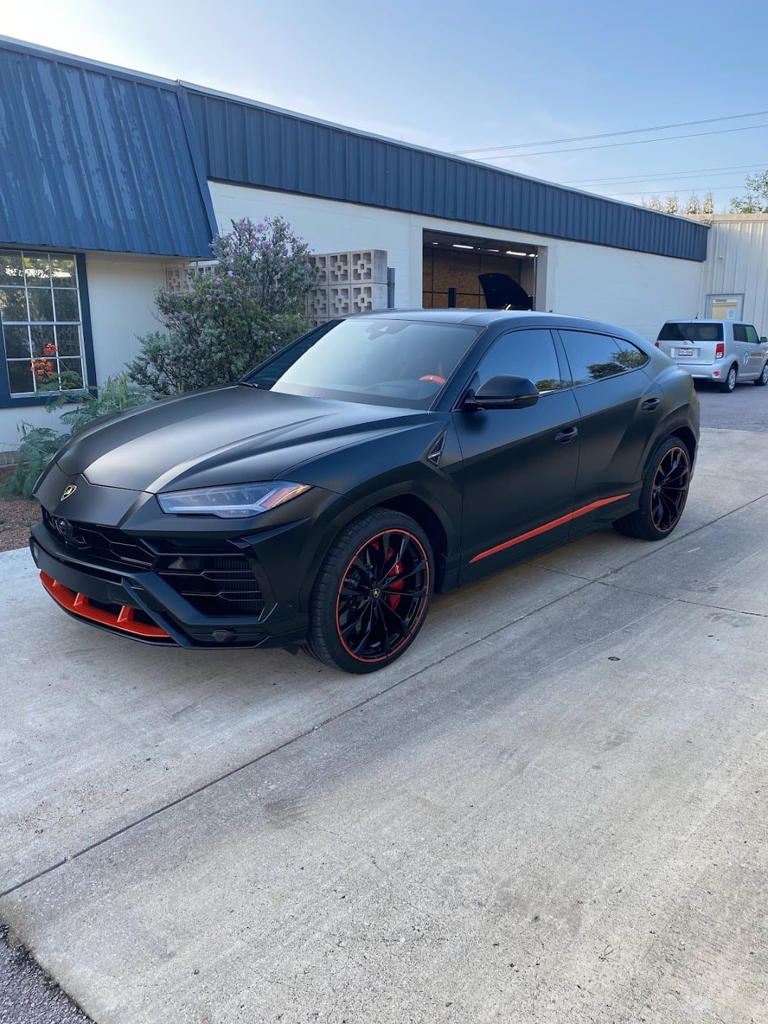 Black Lamborghini Urus outside the shop